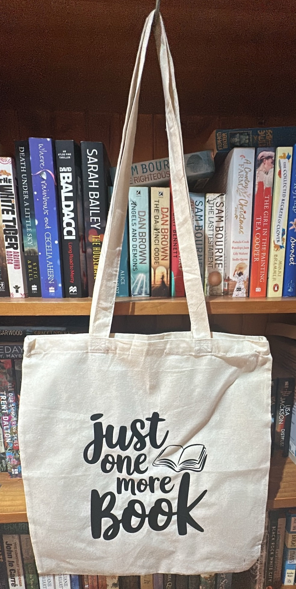 Cream tote with black writing Just One More Book